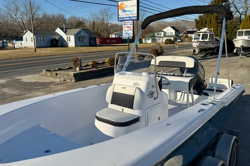 Slide: The Image of 2026 Tidewater 180 CC Adventure boat displayed outdoors on a sunny day. - 13