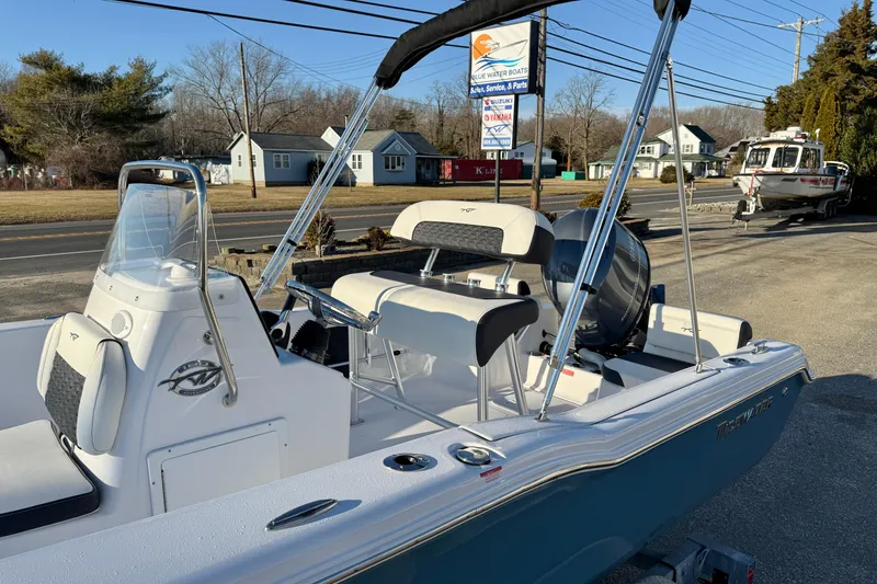 Slide: The Image of 2026 Tidewater 180 CC Adventure boat with sleek design, parked outdoors on a sunny day. - 14