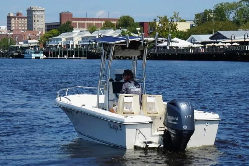 Slide: The Image of 2002 KenCraft Challenger 180 boat on water, cityscape in background. - 3