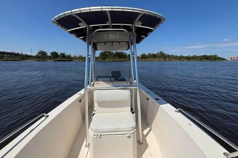 Slide: The Image of 2002 KenCraft Challenger 180 boat on calm water with clear blue sky. - 6