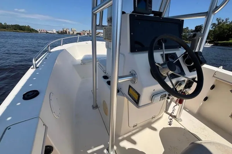 Slide: The Image of 2002 KenCraft Challenger 180 boat interior with steering wheel, on a sunny day. - 8
