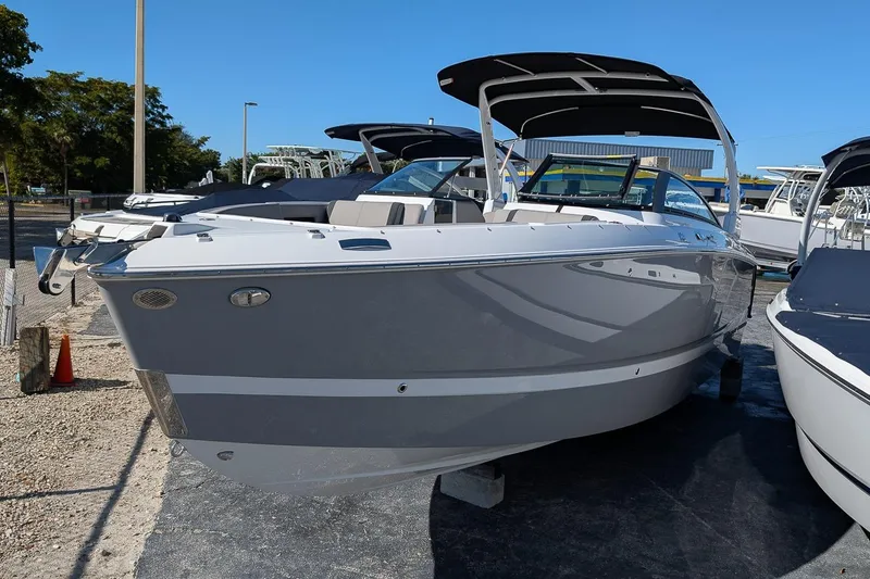 Slide: The Image of 2026 Four Winns H6 OB boat displayed outdoors on a sunny day. - 1