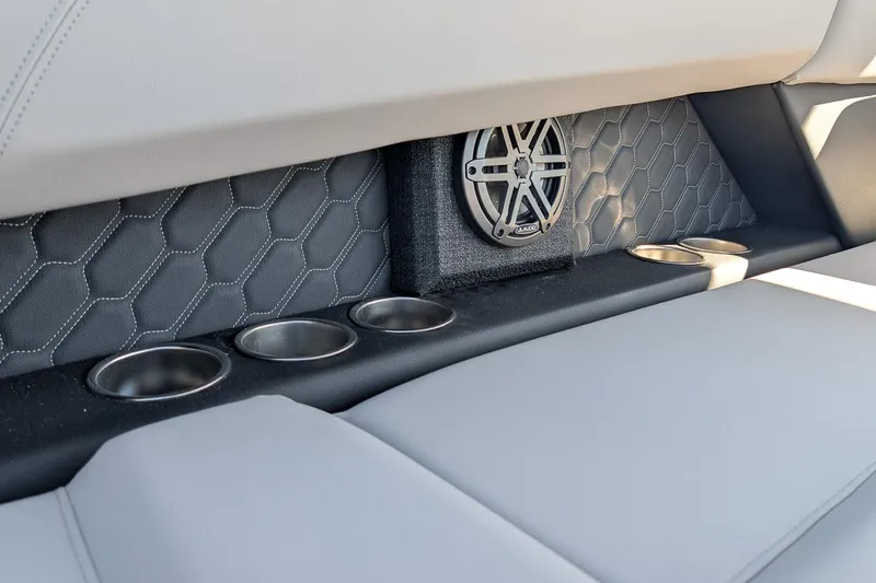 Slide: The Image of 2026 Four Winns H6 OB interior with speaker, cup holders, and hexagonal stitching. - 10