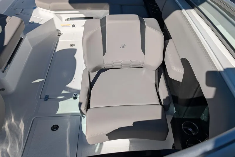 Slide: The Image of 2026 Four Winns H6 OB boat interior with gray seating and cup holders. - 17