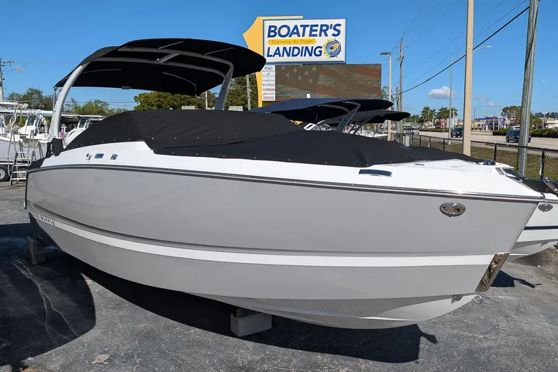 Slide: The Image of 2026 Four Winns H6 OB boat at Boater's Landing dealership, covered and ready for display. - 23