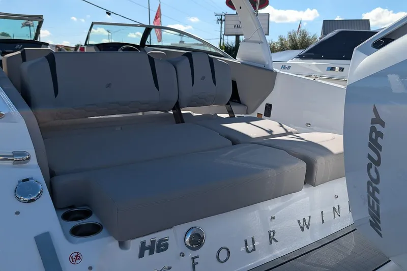 Slide: The Image of 2026 Four Winns H6 OB boat interior with comfortable seating and Mercury branding. - 5