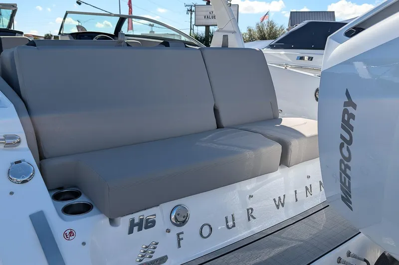 Slide: The Image of 2026 Four Winns H6 OB boat with gray seating and Mercury engine. - 6