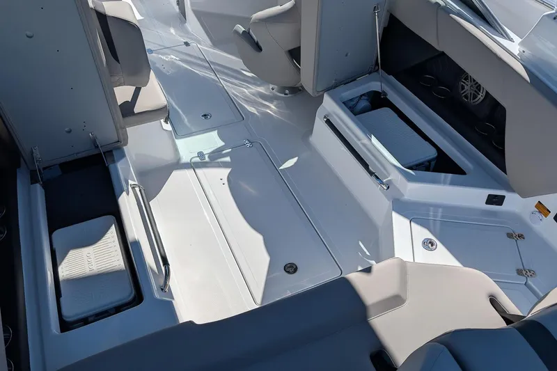 Slide: The Image of 2026 Four Winns H6 OB boat interior with seating and storage compartments. - 9