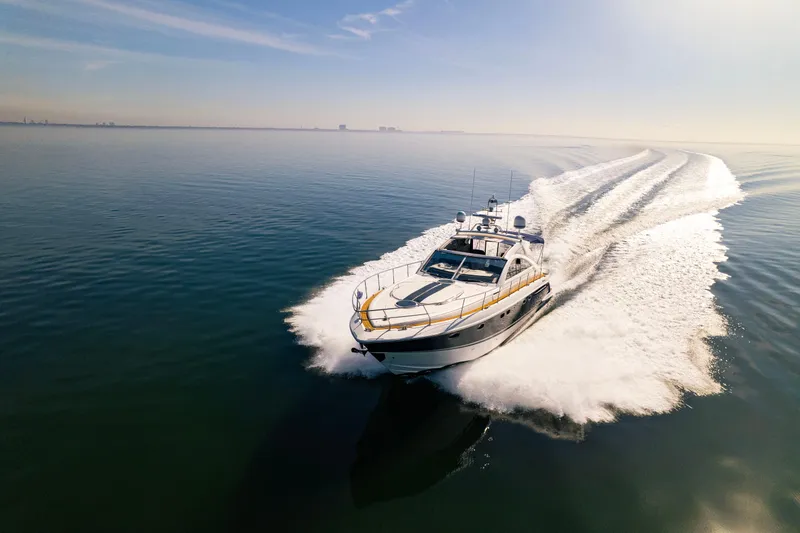 The Image of 2009 Fairline Targa 52 yacht cruising on calm ocean waters under clear skies. - 0