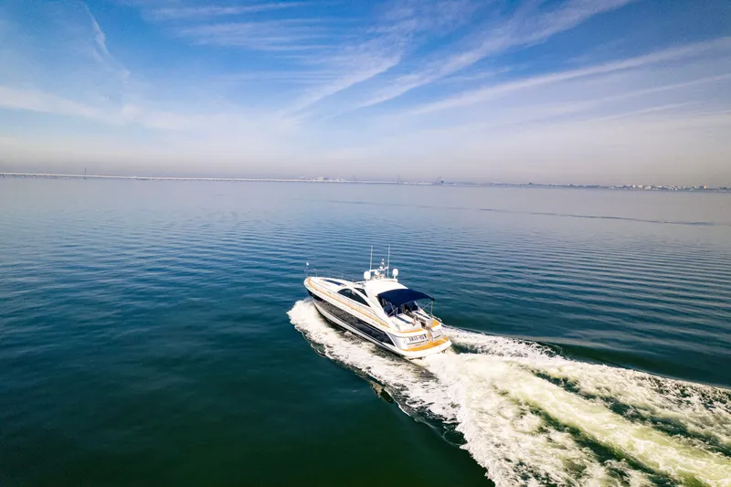 Slide: The Image of 2009 Fairline Targa 52 yacht cruising on calm blue waters under a clear sky. - 23