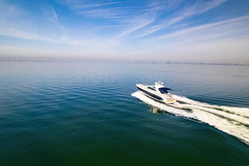 Slide: The Image of 2009 Fairline Targa 52 yacht cruising on calm blue waters under a clear sky. - 24