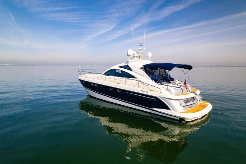 Slide: The Image of 2009 Fairline Targa 52 yacht cruising on calm waters under a clear sky. - 38
