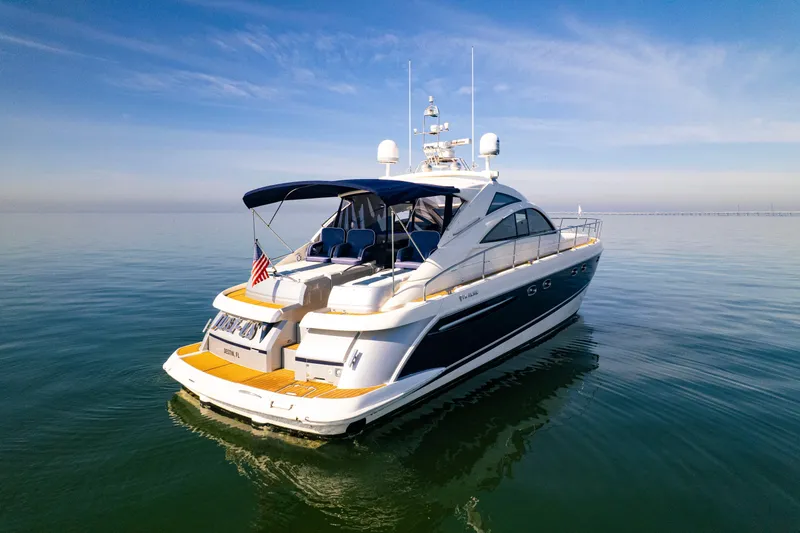 Slide: The Image of 2009 Fairline Targa 52 yacht on calm water under clear blue sky. - 6