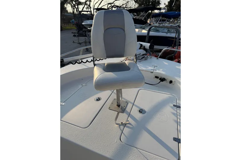 Slide: The Image of 2012 Carolina Skiff 21 Ultra Elite boat seat on deck, showcasing storage compartments. - 10