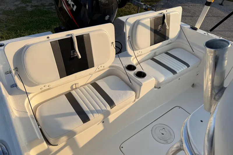 Slide: The Image of 2012 Carolina Skiff 21 Ultra Elite boat interior with cushioned seating and cup holders. - 13