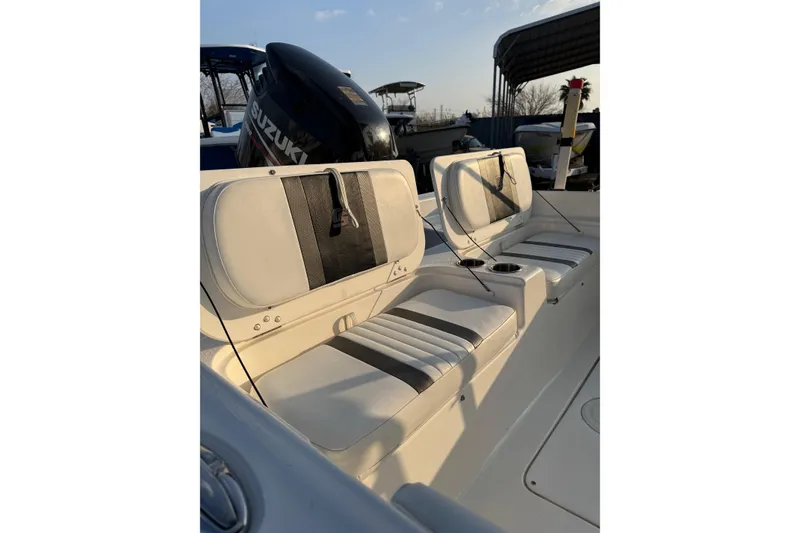 Slide: The Image of 2012 Carolina Skiff 21 Ultra Elite boat interior with seating and Suzuki outboard motor. - 2
