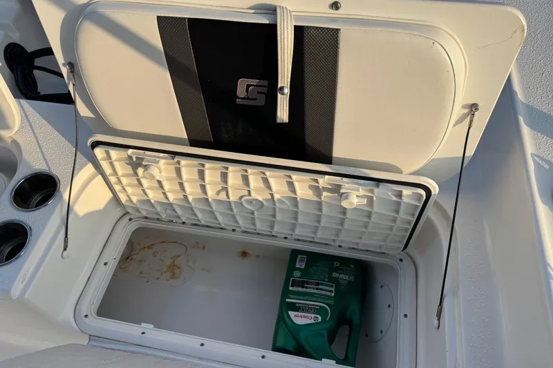 Slide: The Image of 2012 Carolina Skiff 21 Ultra Elite storage compartment with Castrol oil container. - 5