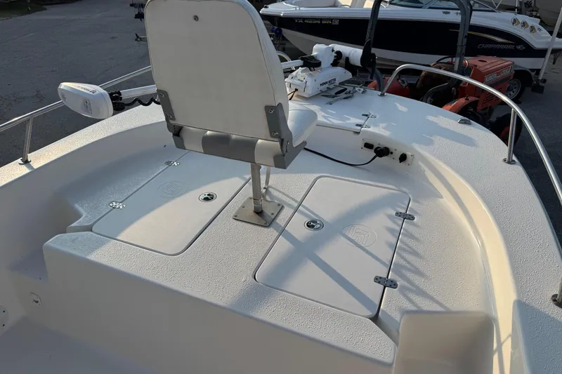 Slide: The Image of 2012 Carolina Skiff 21 Ultra Elite boat deck with seating and storage compartments. - 7