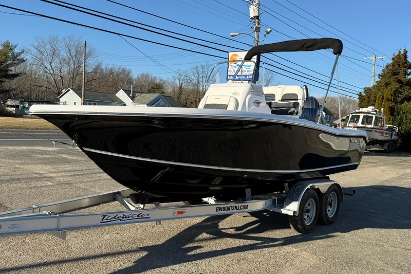 Slide: The Image of 2026 Tidewater 198 CC Adventure boat on trailer, parked outdoors. - 10