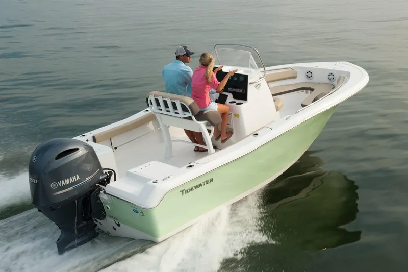 Slide: The Image of 2026 Tidewater 198 CC Adventure boat interior with steering console and seating. - 2