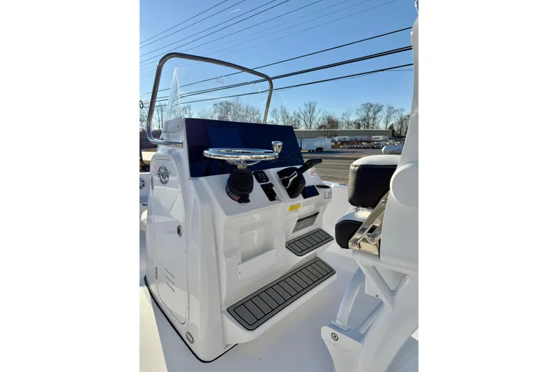 Slide: The Image of 2026 Tidewater 198 CC Adventure boat console with steering wheel and controls. - 21