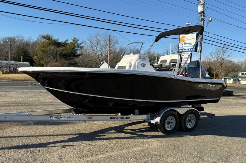 Slide: The Image of 2026 Tidewater 198 CC Adventure boat on trailer, parked outdoors. - 9