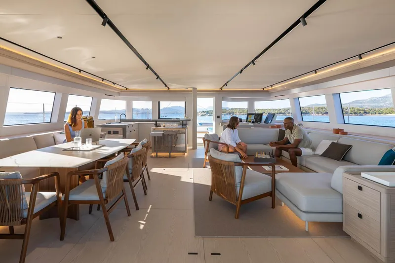 Slide: The Image of Luxurious interior of 2026 Lagoon Eighty 2 yacht with people relaxing and enjoying the view. - 23