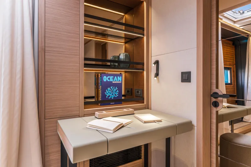 Slide: The Image of Luxurious interior of 2025 Lagoon Eighty 2 yacht with modern desk and shelving. - 27