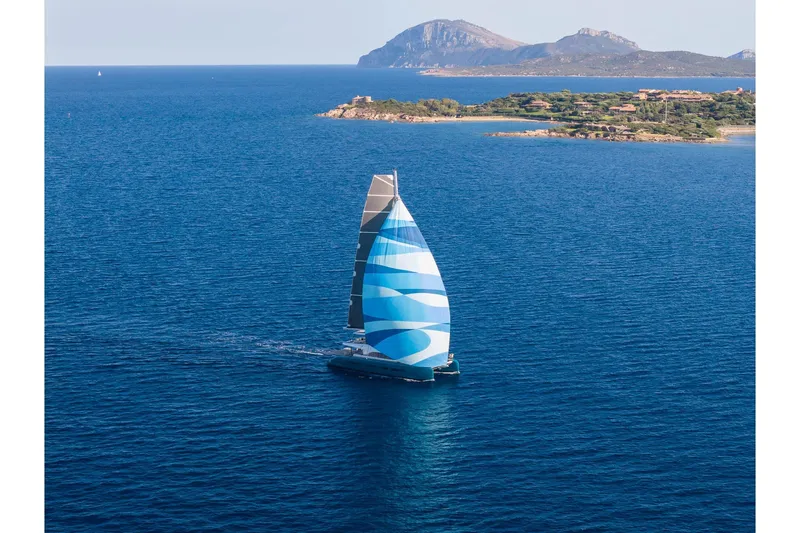 Slide: The Image of Sailing yacht Lagoon Eighty 2, 2026 model, cruising near scenic coastline. - 3