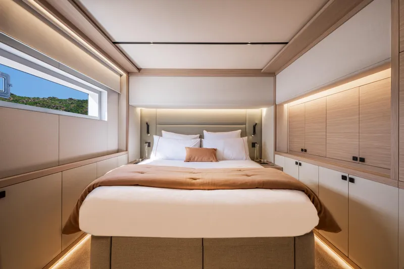 Slide: The Image of Luxurious bedroom interior of 2025 Lagoon Eighty 2 yacht, featuring modern design and elegant lighting. - 34