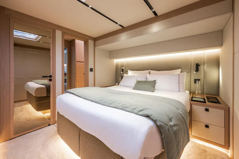 Slide: The Image of Luxurious bedroom interior of 2025 Lagoon Eighty 2 yacht with modern design and ambient lighting. - 38