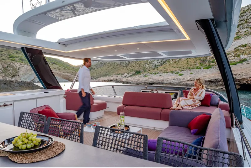 Slide: The Image of Luxurious 2025 Lagoon SIXTY 7 yacht with spacious deck, modern seating, and scenic coastal view. - 11