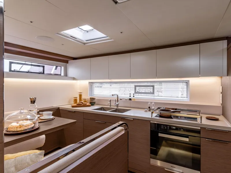 Slide: The Image of Modern kitchen interior of 2025 Lagoon SIXTY 7 yacht, featuring sleek design and appliances. - 14