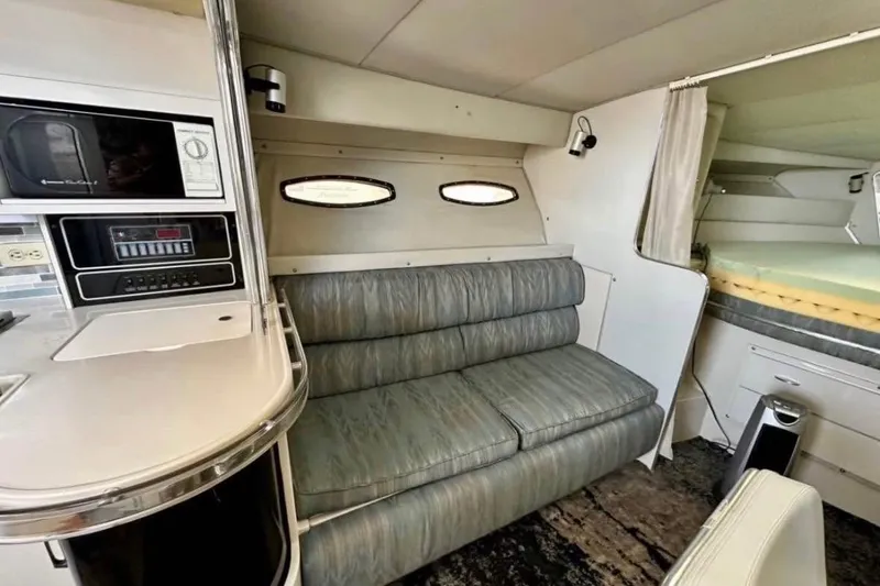 Slide: The Image of Interior of 1987 Wellcraft 3400 Gran Sport yacht with sofa, kitchenette, and sleeping area. - 12