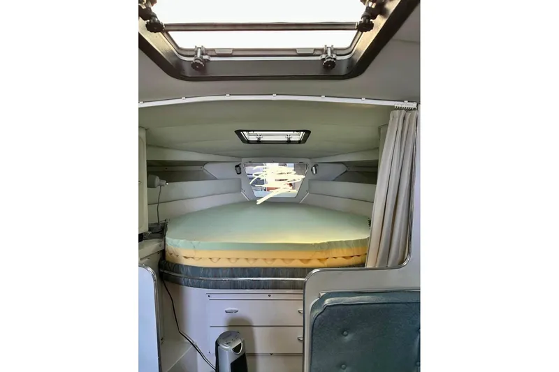 Slide: The Image of Interior cabin of 1987 Wellcraft 3400 Gran Sport boat with bed and storage. - 13