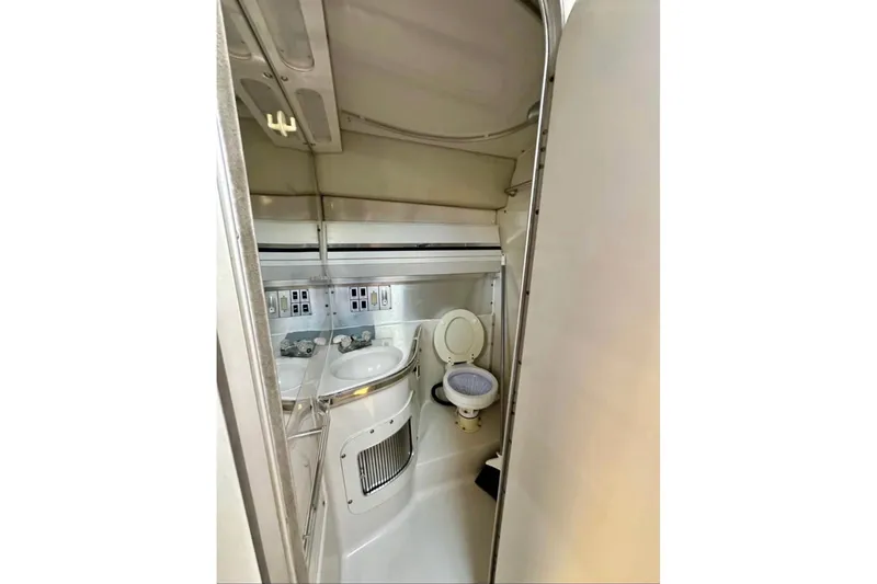Slide: The Image of Interior of 1987 Wellcraft 3400 Gran Sport boat bathroom with toilet and sink. - 14