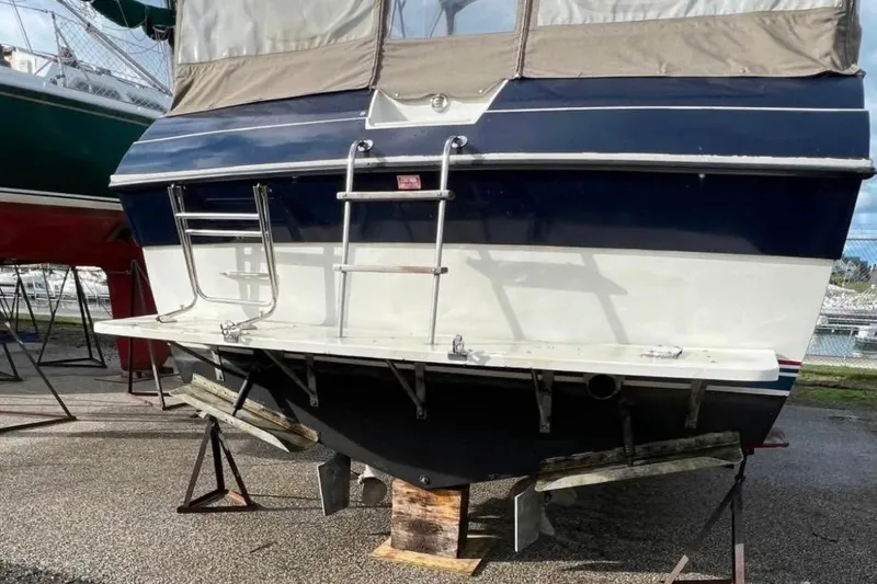 Slide: The Image of 1987 Wellcraft 3400 Gran Sport boat on stands, rear view with ladder and platform. - 17