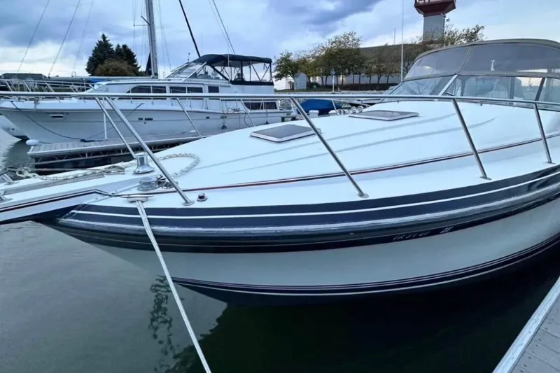 Slide: The Image of 1987 Wellcraft 3400 Gran Sport boat docked in a marina, side view. - 19