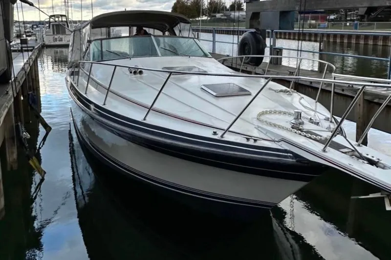 Slide: The Image of 1987 Wellcraft 3400 Gran Sport boat docked in a marina. - 6