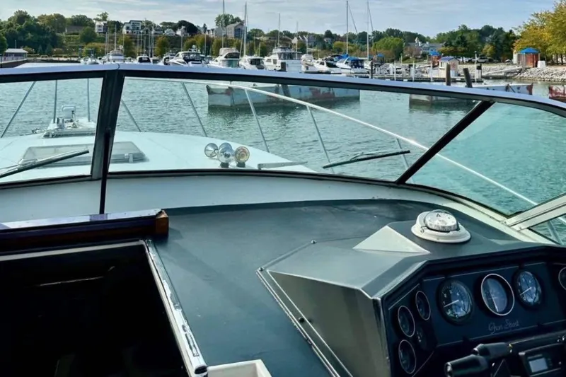 Slide: The Image of 1987 Wellcraft 3400 Gran Sport boat dashboard with marina view in the background. - 8