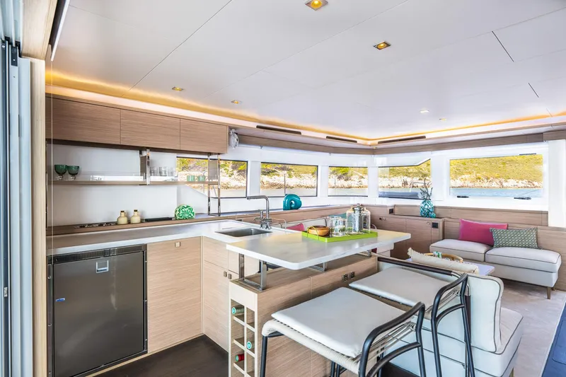 Slide: The Image of Luxurious interior of 2025 Lagoon 60 yacht with modern kitchen and seating area. - 24