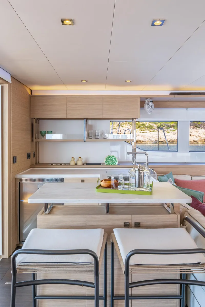 Slide: The Image of Modern kitchen interior of 2025 Lagoon 60 yacht with sleek design and bar seating. - 25