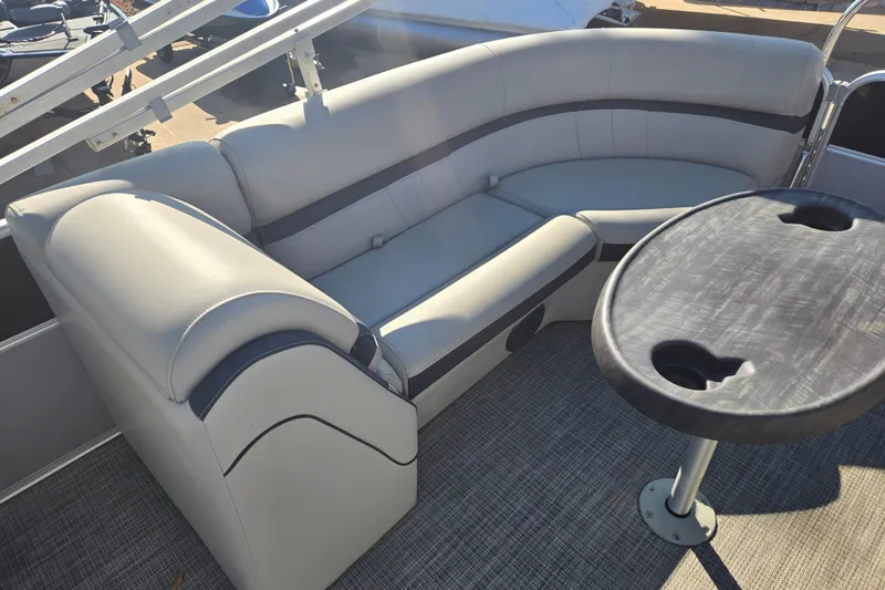 Slide: The Image of 2018 South Bay 200 boat interior with gray seating and round table. - 10
