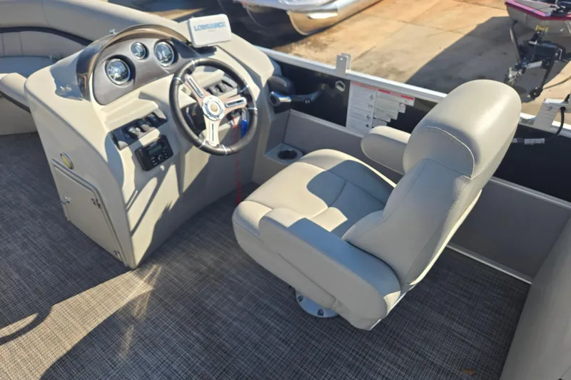 Slide: The Image of 2018 South Bay 200 boat interior with steering wheel and captain's chair. - 12