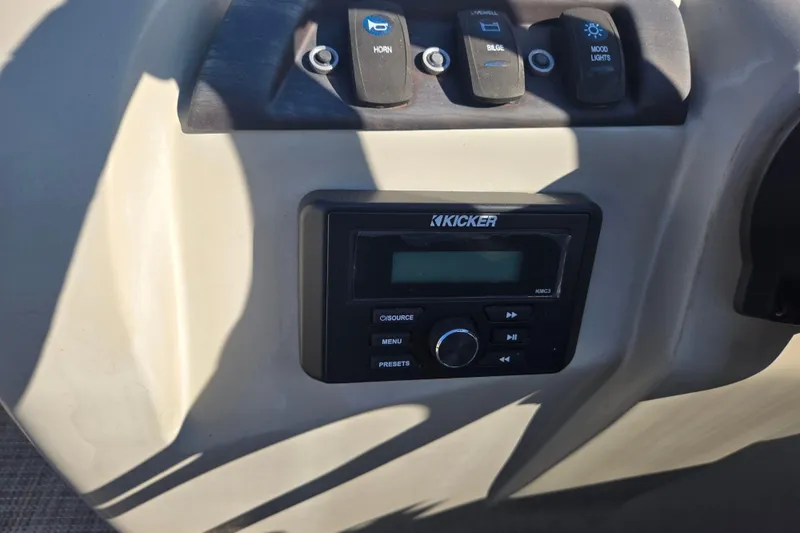Slide: The Image of Control panel of a 2018 South Bay 200 boat with Kicker audio system. - 13
