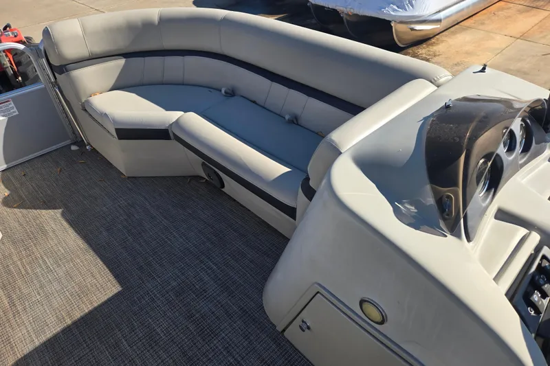 Slide: The Image of 2018 South Bay 200 boat interior with gray seating and dashboard. - 14