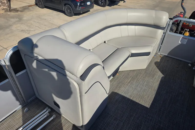 Slide: The Image of 2018 South Bay 200 pontoon boat with gray seating and carpeted deck. - 15