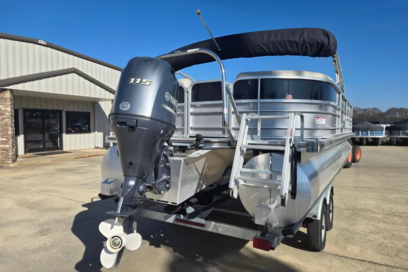 Slide: The Image of 2018 South Bay 200 pontoon boat with Yamaha 115 outboard motor, parked on trailer. - 2