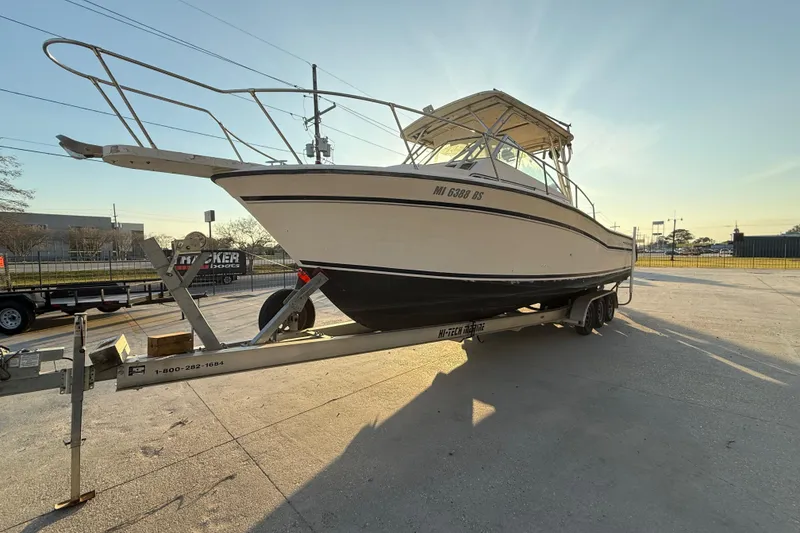 The Image of 1992 Grady White 300 Marlin boat on trailer, parked outdoors in sunlight. - 1
