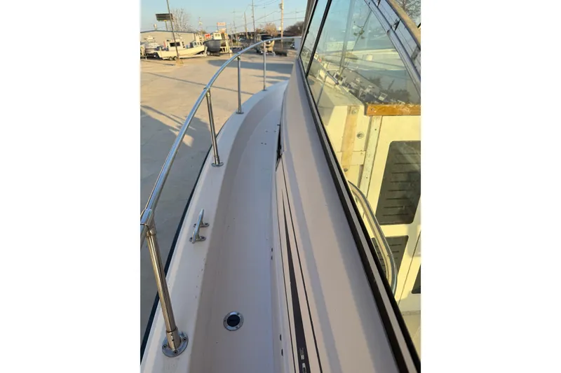 Slide: The Image of 1992 Grady White 300 Marlin boat deck with railing, docked in a marina. - 10